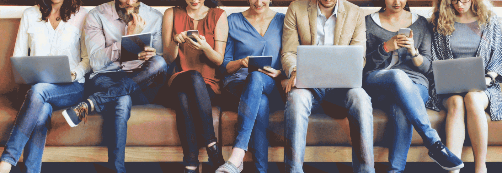 line of people sat down on devices