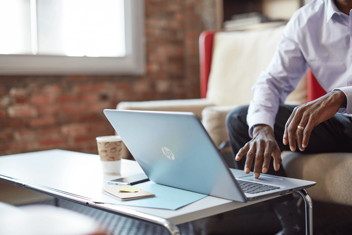 man on hp laptop using hp sure click