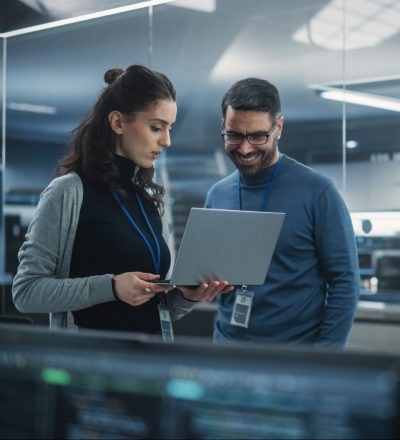 Portrait,Of,Two,Happy,Female,And,Male,Engineers,Using,Laptop